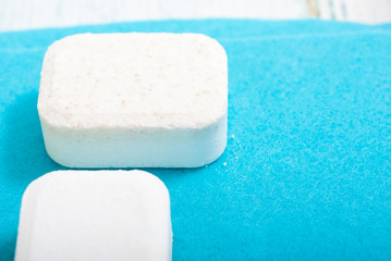 dishwashing products on white wood table