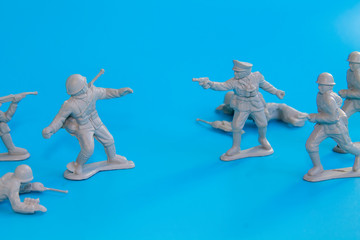 small plastic soldiers standing on a blue background