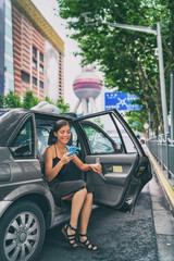 Woman using online mobile payment app for taxi cab