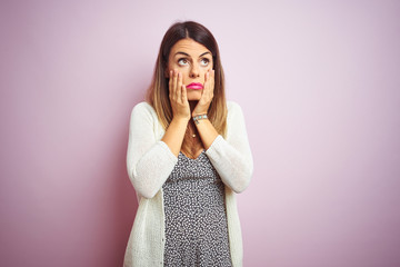 Young beautiful woman standing over pink isolated background Tired hands covering face, depression and sadness, upset and irritated for problem