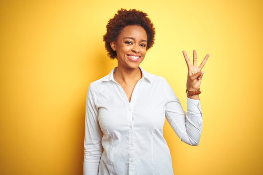 African American Business Woman Over Isolated Yellow Background Showing And Pointing Up With Fingers Number Three While Smiling Confident And Happy.