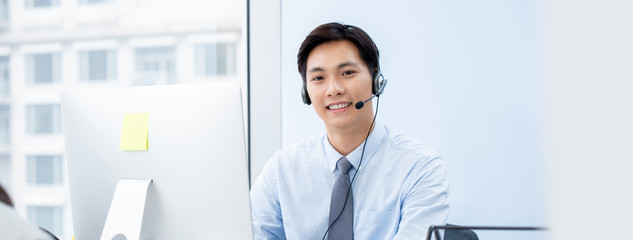 Asian man telemarketing agent  in call center office banner background