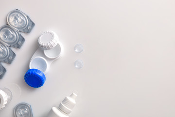 Contact lenses containers and solutions on white table top