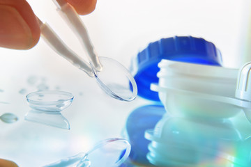 Manipulating a lens reflected on a glass table bluish