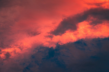 Fototapeta na wymiar Dramatic moody stormy sky with red sunset light.