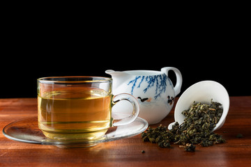 Chinese tea with glass cup on wooden and dark background