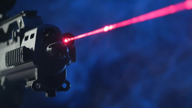 automatic rifle on a dark background with a telescopic sight