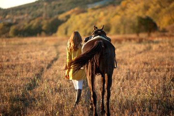 A young girl leads a horse under the prisoners.