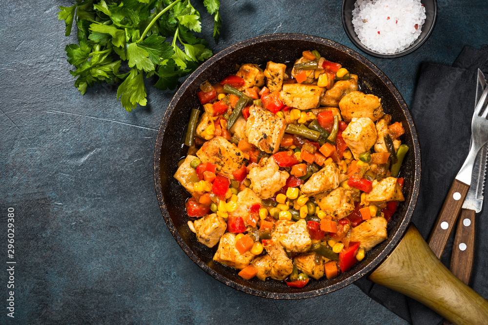 Wall mural chicken stir fry with vegetables top view.