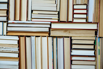 Many Books Piles. Hardback books on wooden table. Books stack texture and background. Back to...