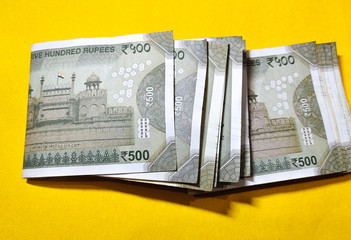 Indian five hundred rupee notes on the yellow background