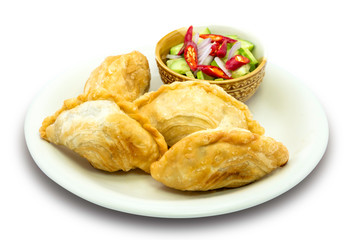 Curry puff pastry isolated on wooden table background with clipping path.