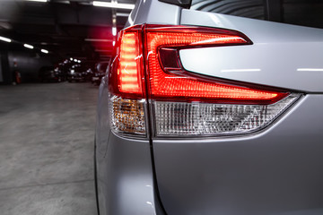 Close-up taillight of a new halogen silver crossover car. Exterior of a modern car.