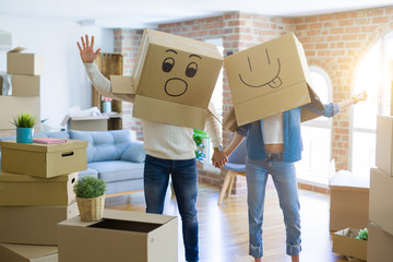 Funny couple wearing cardboard boxes with fun crazy emoji faces over head
