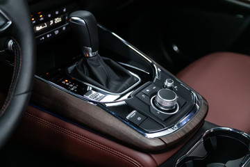 Close-up of the accelerator handle and buttons with  modern central console with  controls. automatic transmission gear of car , car interior.
