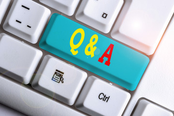 Text sign showing Q And A. Business photo showcasing a period of time or an occasion when someone answers questions White pc keyboard with empty note paper above white background key copy space