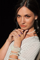 Obraz premium Portrait of a beautiful brunette woman in a striped dress