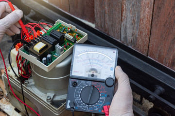 Closeup technician man hand repairing and checking  the functional of home electric auto door...