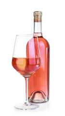 Glass and bottle of tasty wine on white background