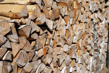harvesting firewood stacked tightly to each other on a Sunny day