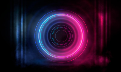 Neon circle on a dark street background, wet asphalt. Blue neon, smoke, smog. Night view of a street with neon. Abstract neon dark background.