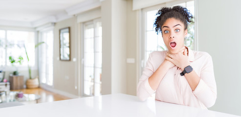 Wide angle of beautiful african american woman with afro hair shouting suffocate because painful strangle. Health problem. Asphyxiate and suicide concept.