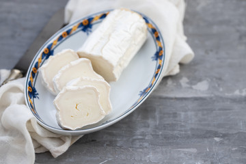 goat cheese on dish on dark ceramic background