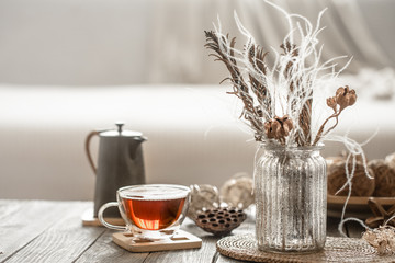 home decor beautiful vase with flowers and a Cup of tea.
