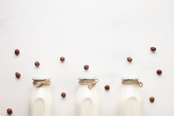 Milk and hazelnuts on white background