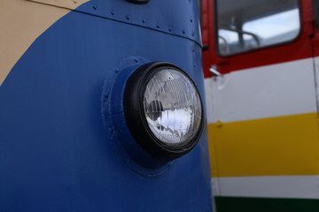 Large, round headlight of a retro Soviet bus.