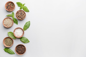 Bowls with different spices on white background