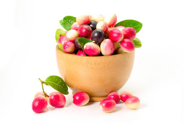 Closeup fresh Carissa carandas Linn or Karanda ,Carunda ,Karonda , Bengal currants ,Koromcha fruits in wooden bowl isolated on white background.  Healthy food,fruit concept. 