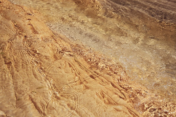 in the mountains there is a mountain river and a waterfall