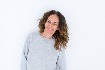 Beautiful middle age woman with curly hair smiling cheerful and happy, laughing with a big smile on face showing teeth over white isolated background
