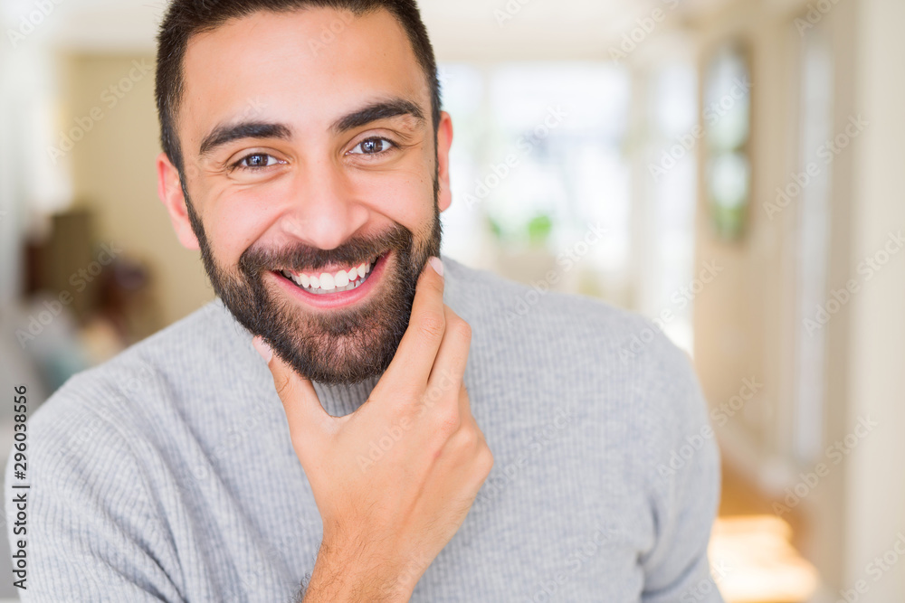 Wall mural handsome man smiling cheerful with a big smile on face showing teeth, positive and happy expression