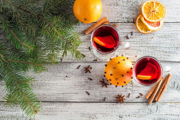 christmas hot mulled wine with cinnamon orange and anise on white wooden background