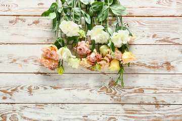 Beautiful eustoma flowers on white wooden background