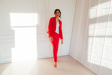 Portrait of a beautiful female student in a red business suit