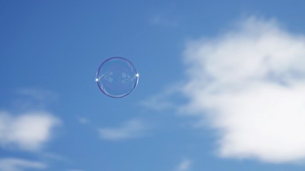 a soap bubble in the air with blue sky in the background