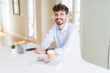 Handsome young man smiling cheerful at the camera with a big smile on face showing teeth