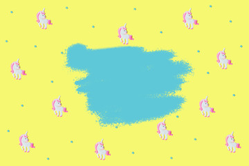 Blue stars and pink unicorns on yellow backdrop.