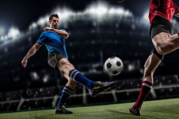 Soccer player in action on night stadium background