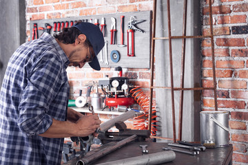 Metalworker tightening a bolt or clamp