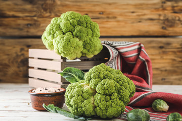 Different fresh cabbage on wooden table