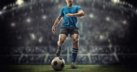 Soccer player in action on a dark background