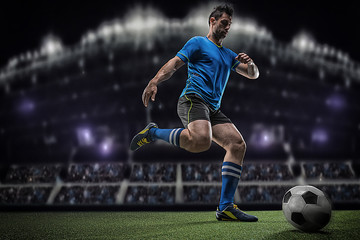 Football player with ball on field of stadium