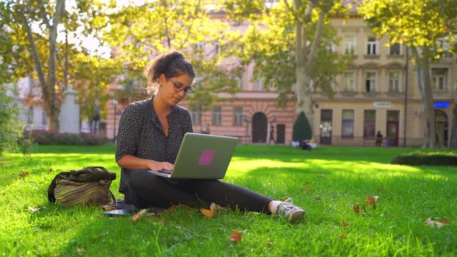 Image of attractive woman studying with a notebook at a public park, Croatia.