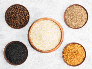 Spices set and rice on white concrete background. Modern apothecary, naturopathy and ayurveda concept.