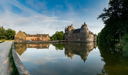 Fototapeta na wymiar view of the historic Chateau Trecesson castle in the Broceliande Forest with reflections in the pond