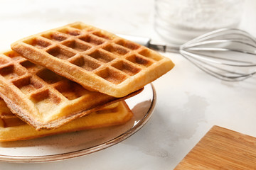 Plate with tasty waffles on table, closeup